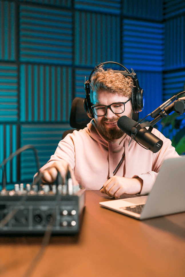 cheerful-young-man-recording-podcast-studio-confident-man-with-headphones-microphone 2 (1) (1)